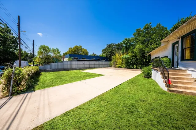 a view of a backyard with plants and a garden