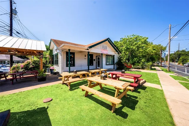 a view of swimming pool with lounge chairs in front of house