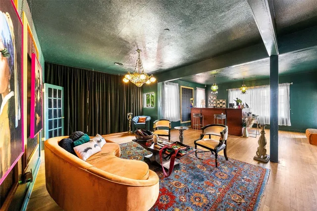 a living room with furniture and a chandelier