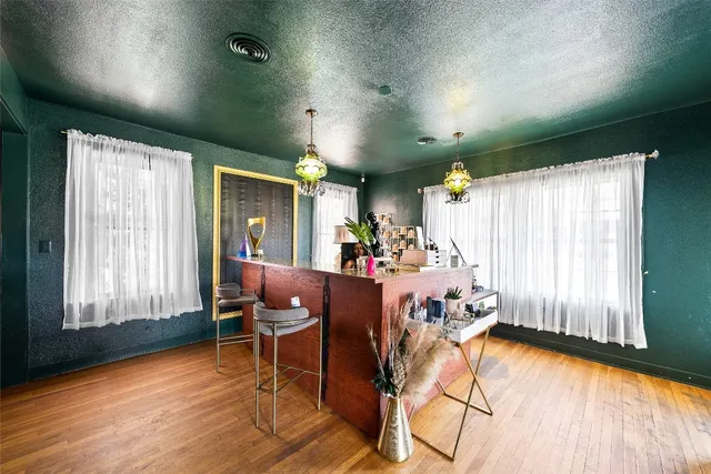 a view of a dining room with furniture and wooden floor