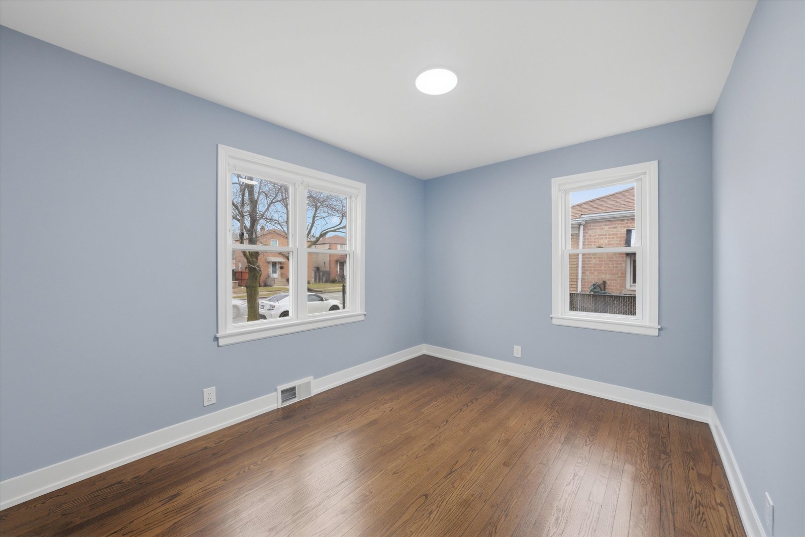 3743 West 83rd Street Chicago, IL 60652 - Photo 14 of 51 a view of an empty room with wooden floor and a window