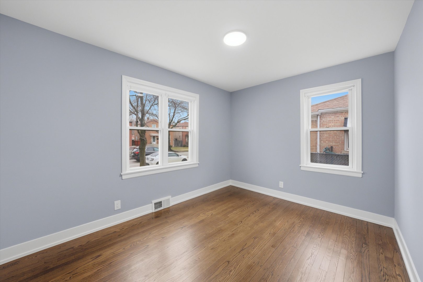 3743 West 83rd Street Chicago, IL 60652 - Photo 16 of 51 a view of an empty room with wooden floor and a window