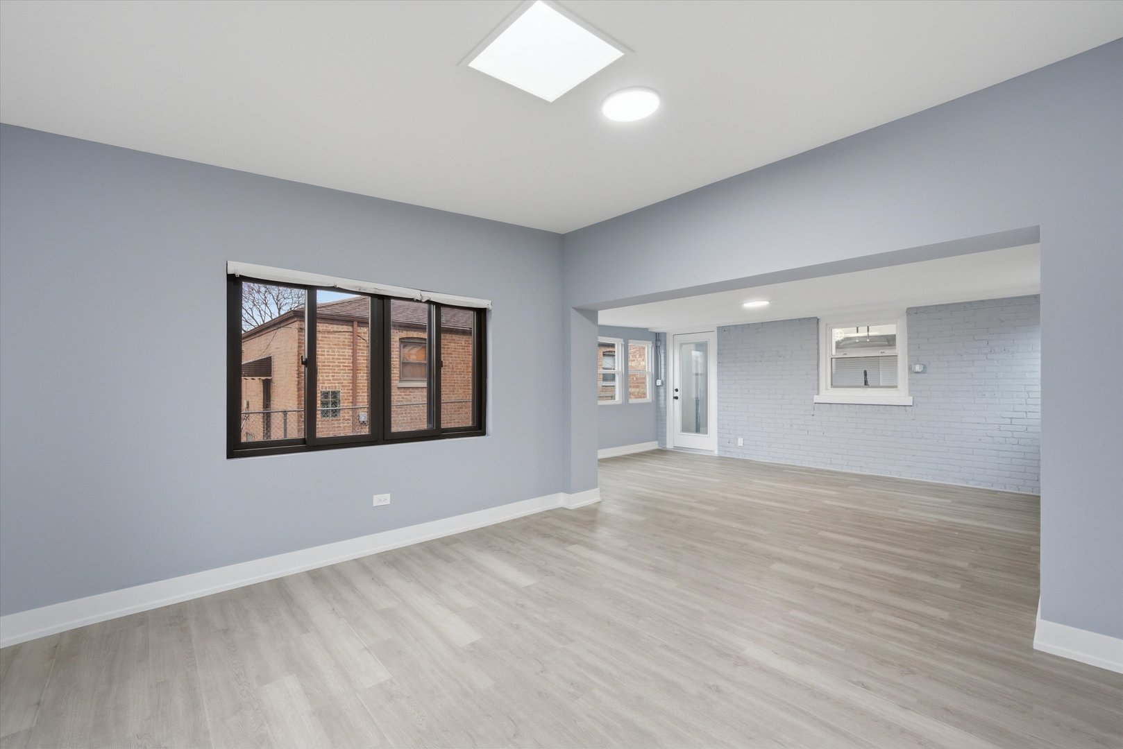 3743 West 83rd Street Chicago, IL 60652 - Photo 20 of 51 a view of an empty room with a window and wooden floor