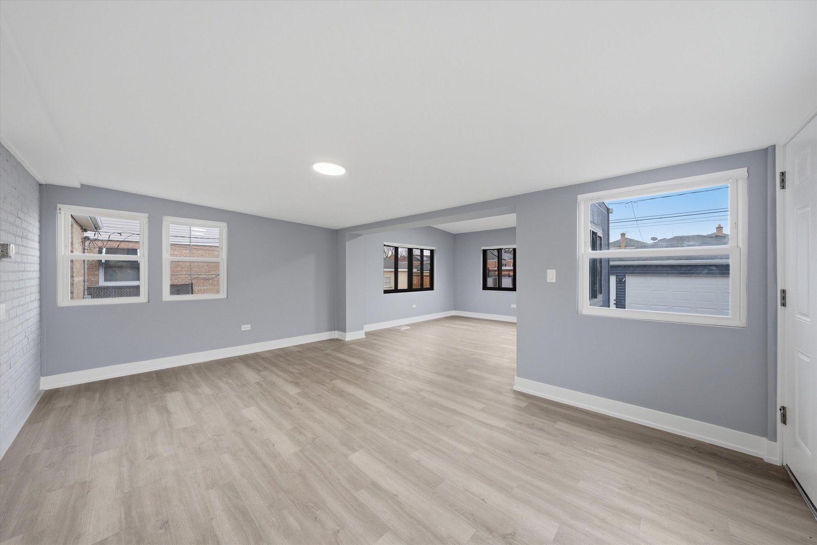 3743 West 83rd Street Chicago, IL 60652 - Photo 21 of 51 a view of an empty room with a window and wooden floor