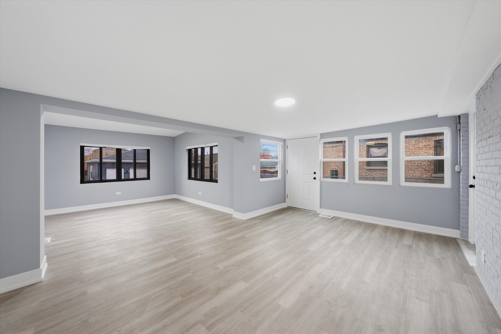 3743 West 83rd Street Chicago, IL 60652 - Photo 22 of 51 a view of an empty room with a window and wooden floor