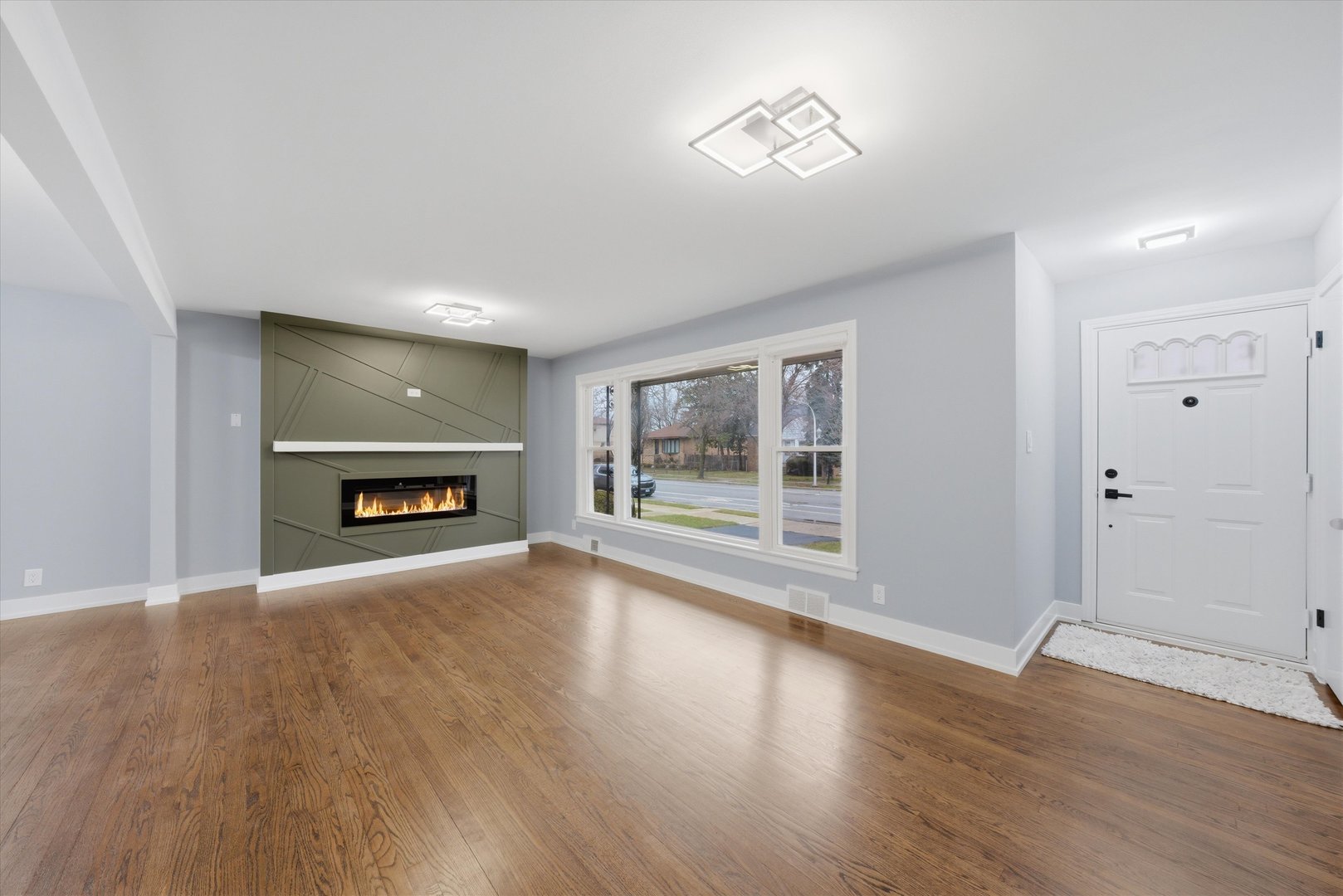 3743 West 83rd Street Chicago, IL 60652 - Photo 7 of 51 an empty room with wooden floor fireplace and windows