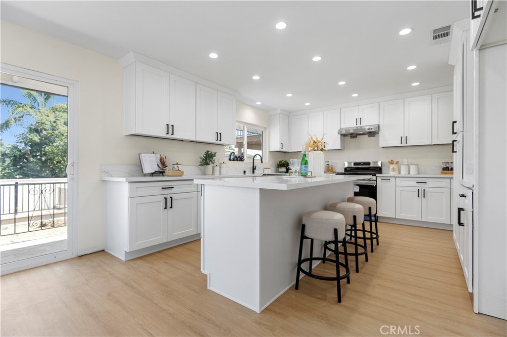 645 Lancer Lane Corona, CA 92879 - Photo 15 of 69 a kitchen with a sink a counter top space and appliances