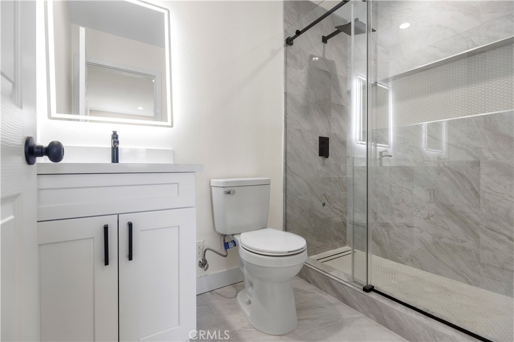 645 Lancer Lane Corona, CA 92879 - Photo 30 of 69 a bathroom with a sink a toilet and shower