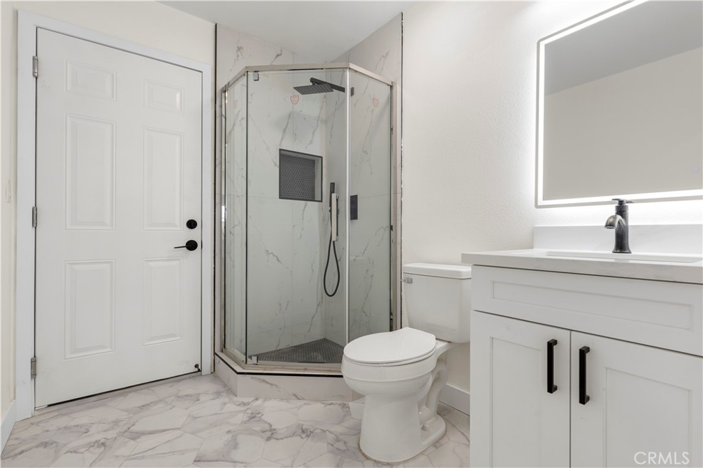 645 Lancer Lane Corona, CA 92879 - Photo 31 of 69 a bathroom with a toilet sink and shower