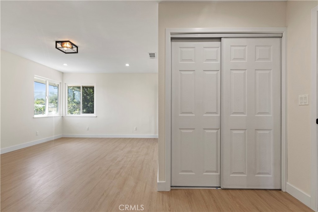 645 Lancer Lane Corona, CA 92879 - Photo 32 of 69 an empty room with wooden floor closet and windows