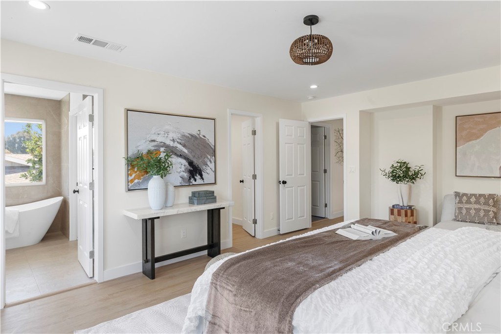 645 Lancer Lane Corona, CA 92879 - Photo 37 of 69 a bedroom with a bed and a chandelier