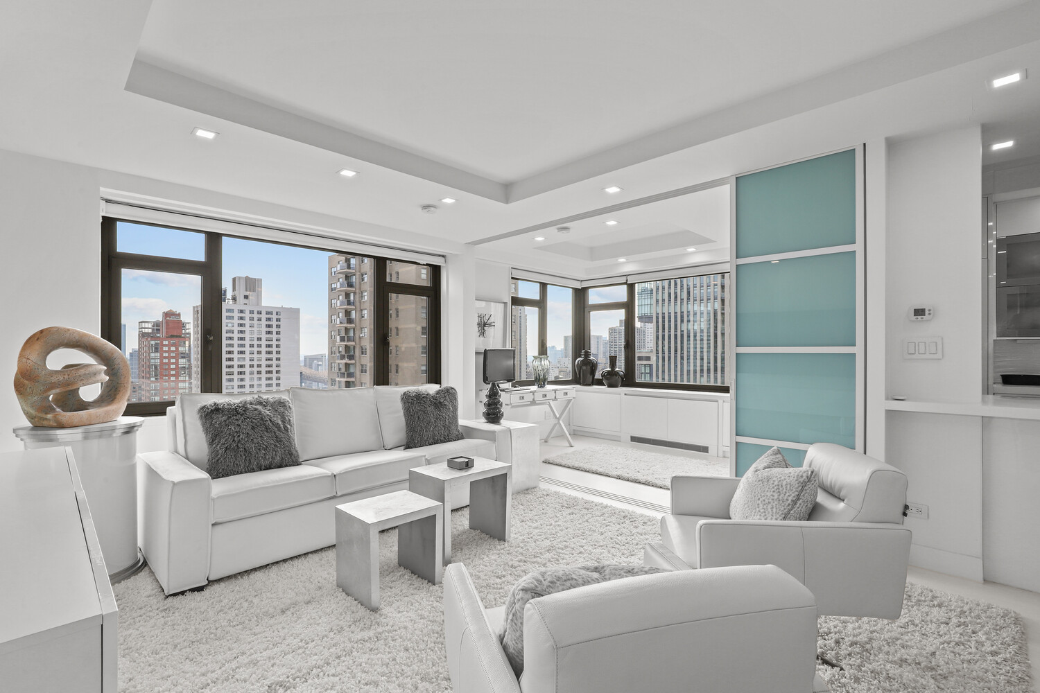 160 East 65th Street, Unit 26B Manhattan, NY 10065 - Photo 3 of 12 a living room with furniture and a large window