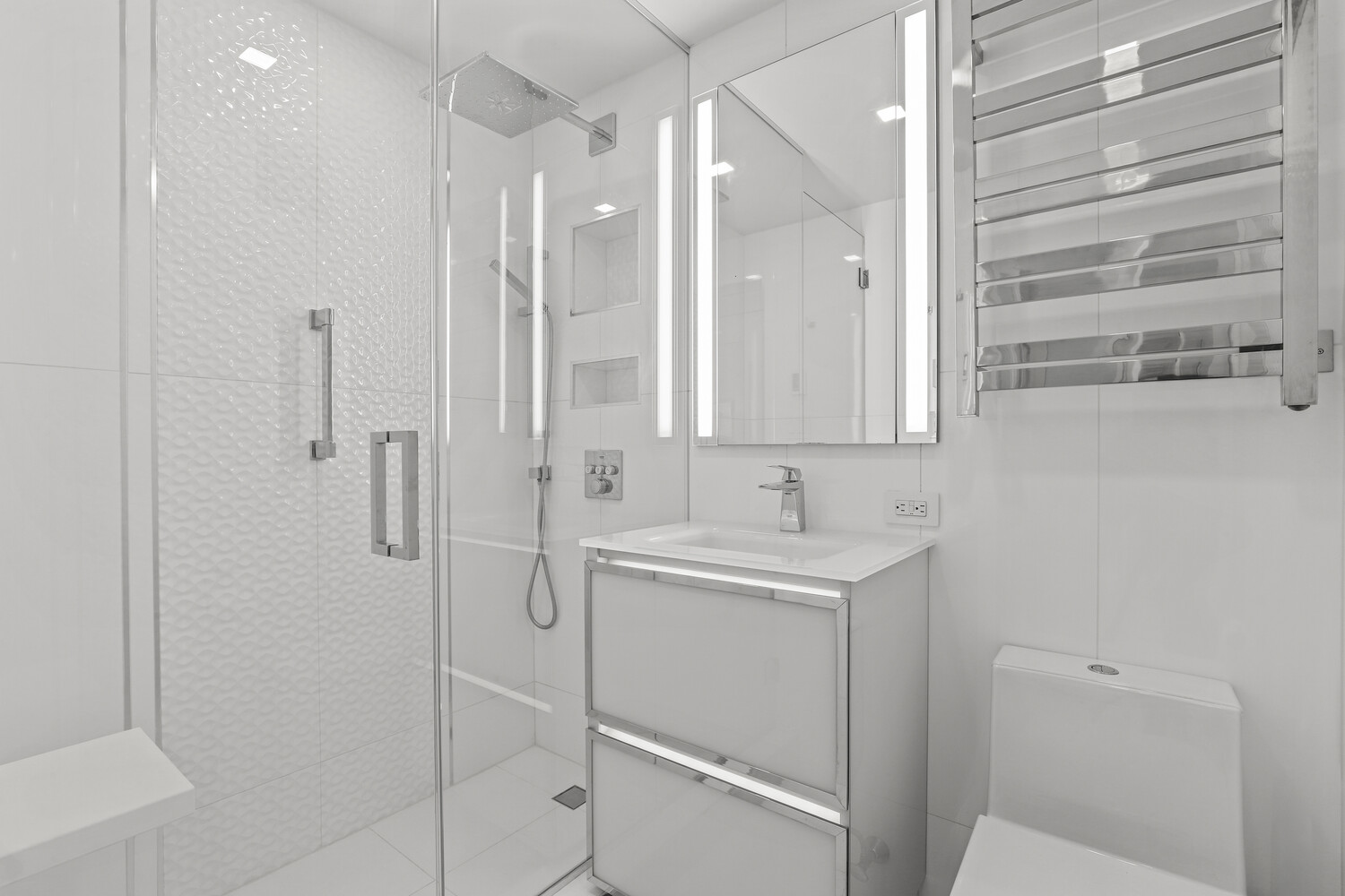160 East 65th Street, Unit 26B Manhattan, NY 10065 - Photo 7 of 12 a bathroom with a shower sink and mirror