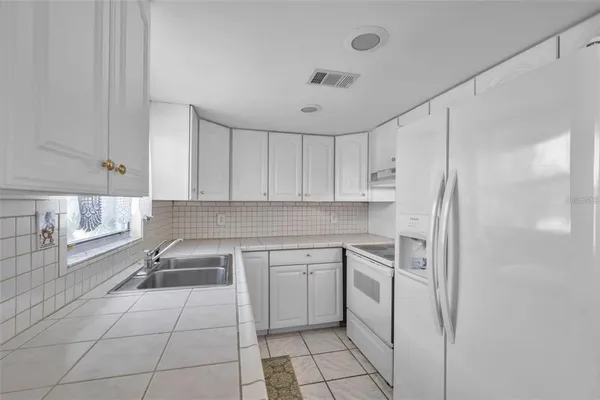 a kitchen with a sink appliances and cabinets
