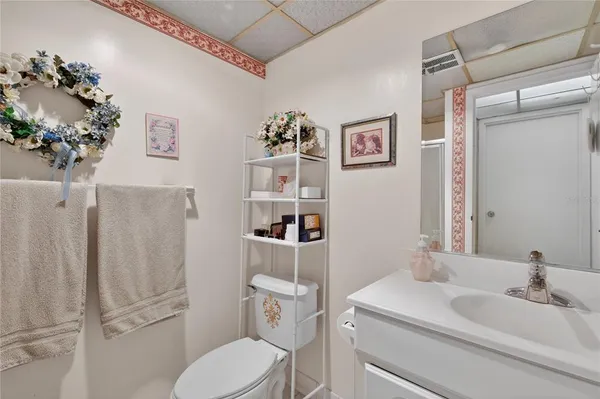 a bathroom with a sink mirror vanity and toilet