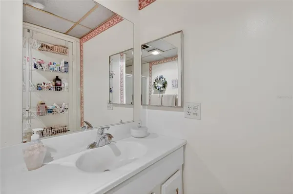 a bathroom with a sink vanity and a mirror