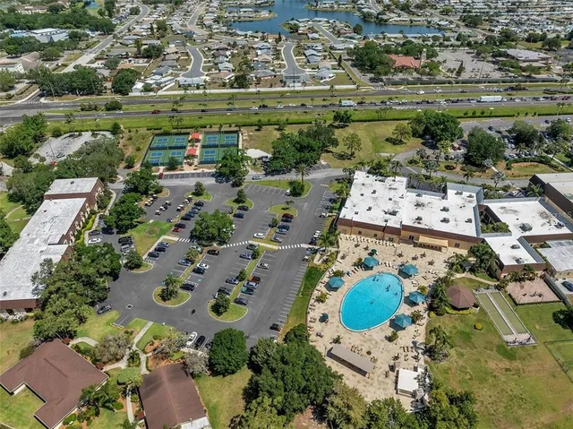 an aerial view of residential houses with outdoor space and swimming pool