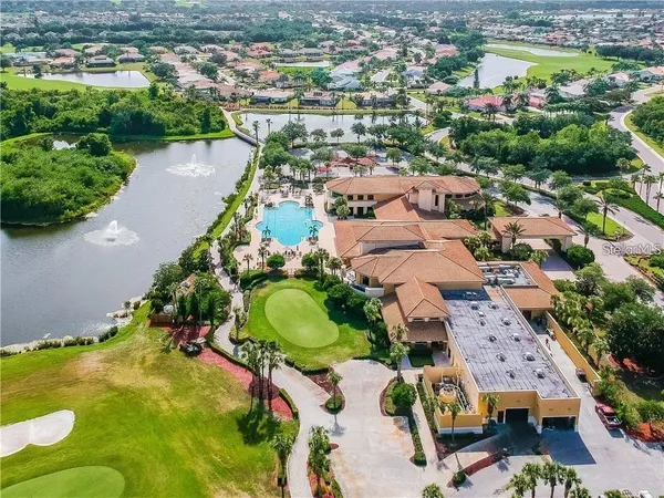an aerial view of ocean and residential houses with outdoor space