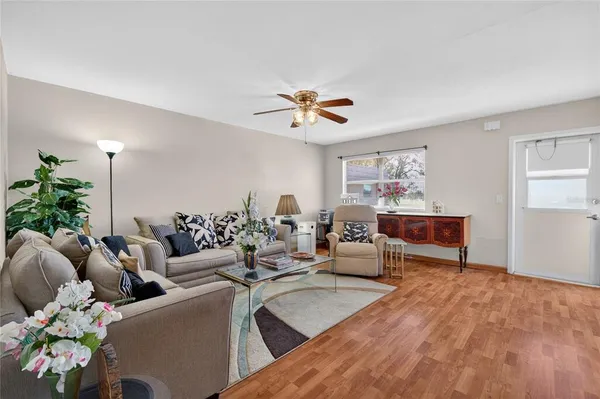 a living room with furniture flower pot and a chandelier