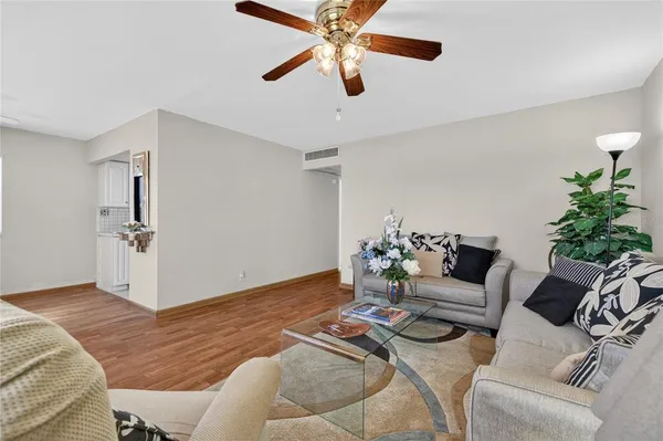 a living room with furniture and a chandelier