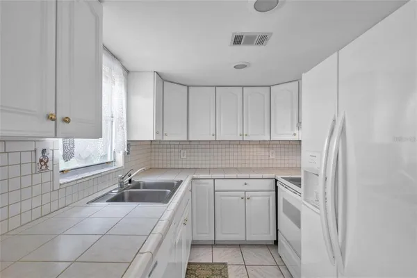 a kitchen with a sink cabinets and utility