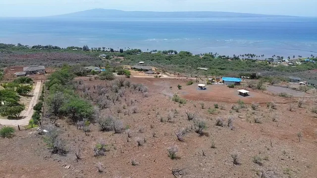 a view of a lake with beach and city view