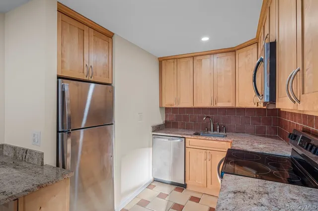 a view of a refrigerator in kitchen and wooden floor