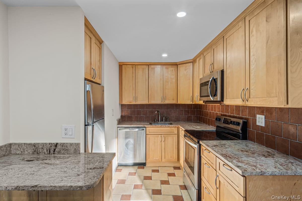 168-11 12th Avenue, Unit 3D Queens, NY 11357 - Photo 11 of 21 a kitchen with a sink stove and cabinets