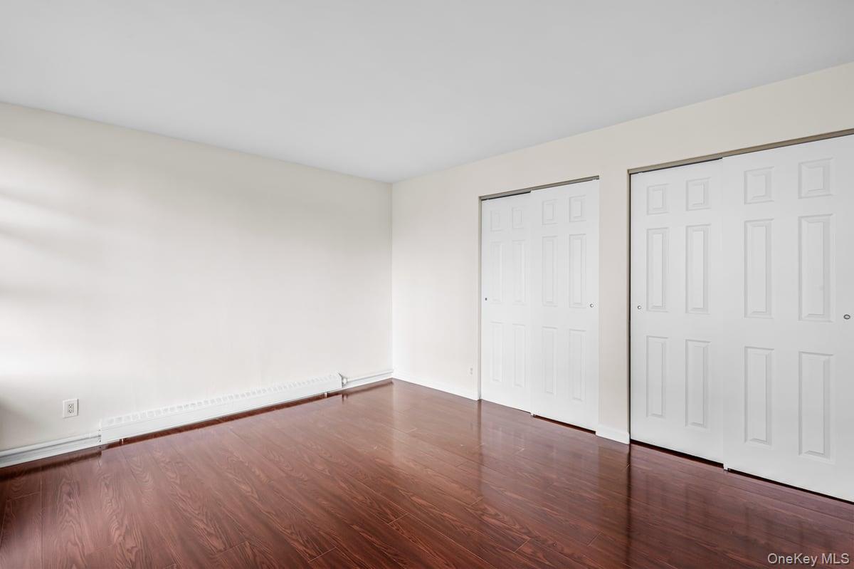 168-11 12th Avenue, Unit 3D Queens, NY 11357 - Photo 12 of 21 a view of an empty room with wooden floor
