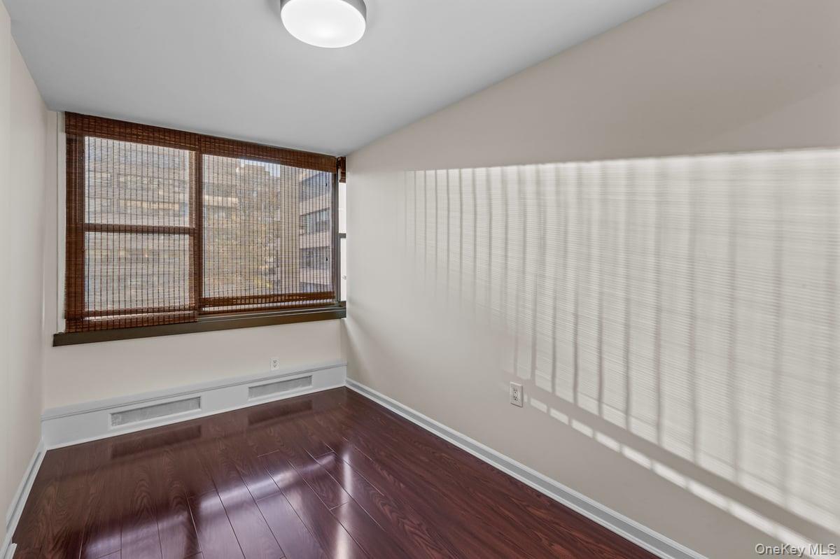 168-11 12th Avenue, Unit 3D Queens, NY 11357 - Photo 16 of 21 a view of a room with wooden floor and a window