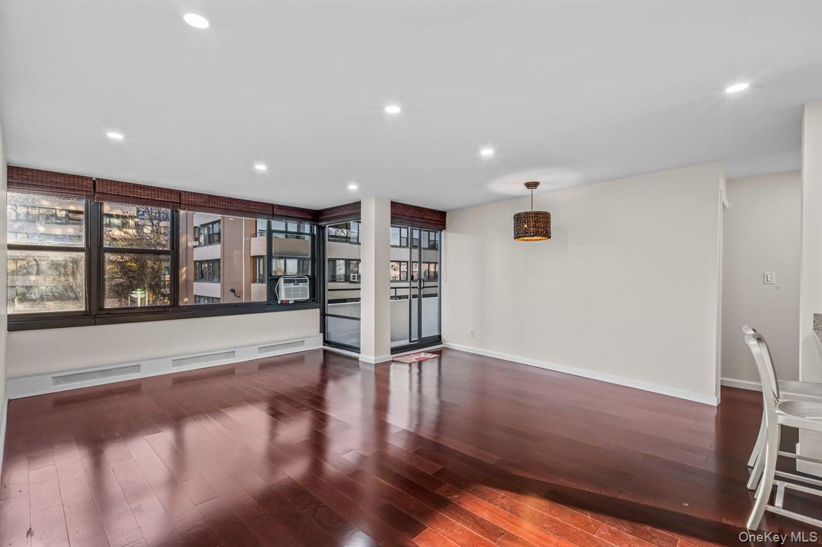 168-11 12th Avenue, Unit 3D Queens, NY 11357 - Photo 4 of 21 a view of an empty room with a window and wooden floor