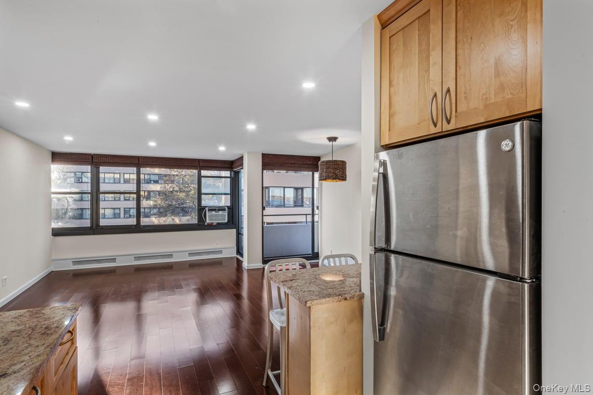 168-11 12th Avenue, Unit 3D Queens, NY 11357 - Photo 9 of 21 a view of a refrigerator in kitchen and wooden floor