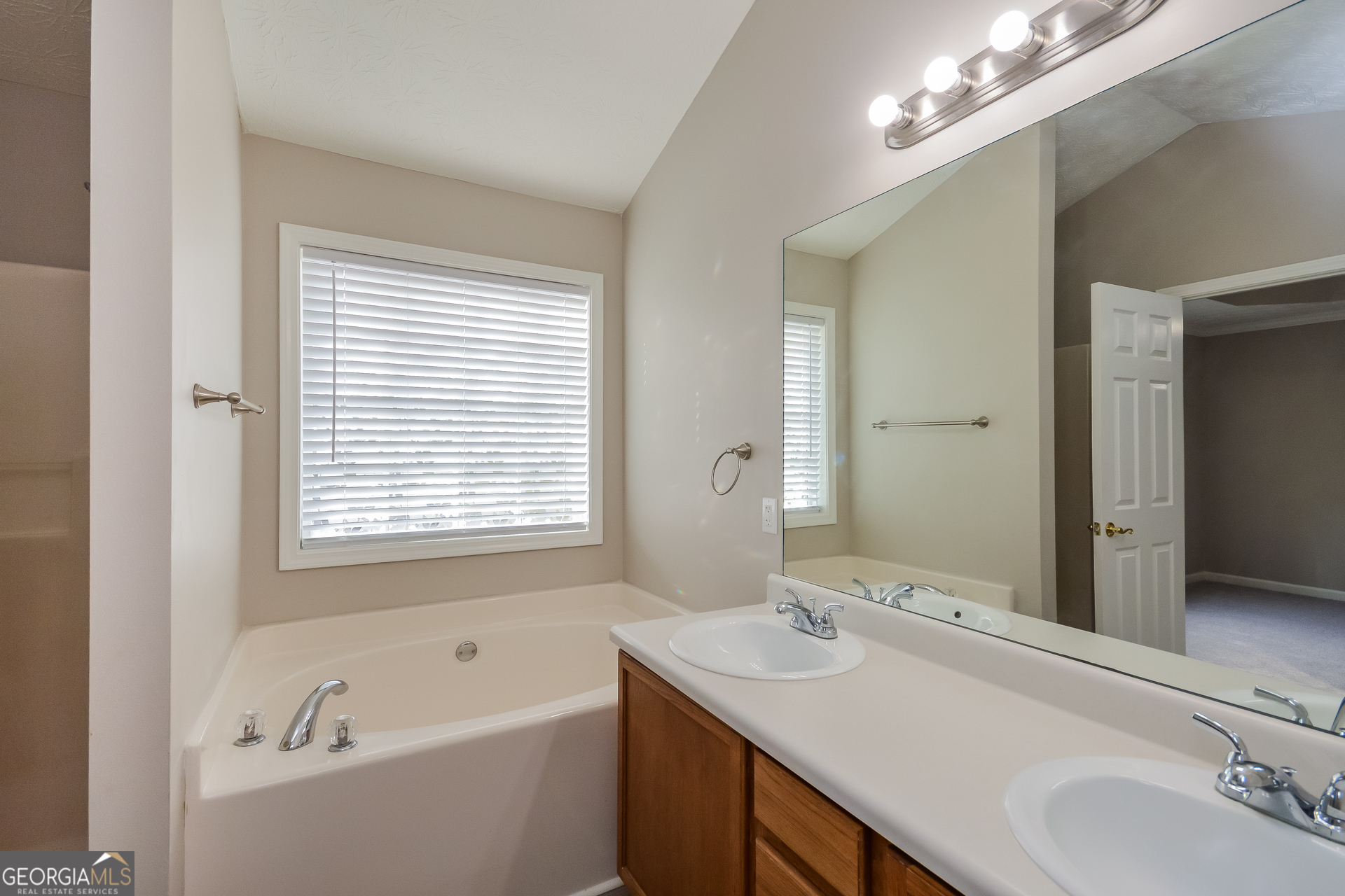 110 Tara Way Covington, GA 30016 - Photo 11 of 17 a bathroom with a tub sink and mirror