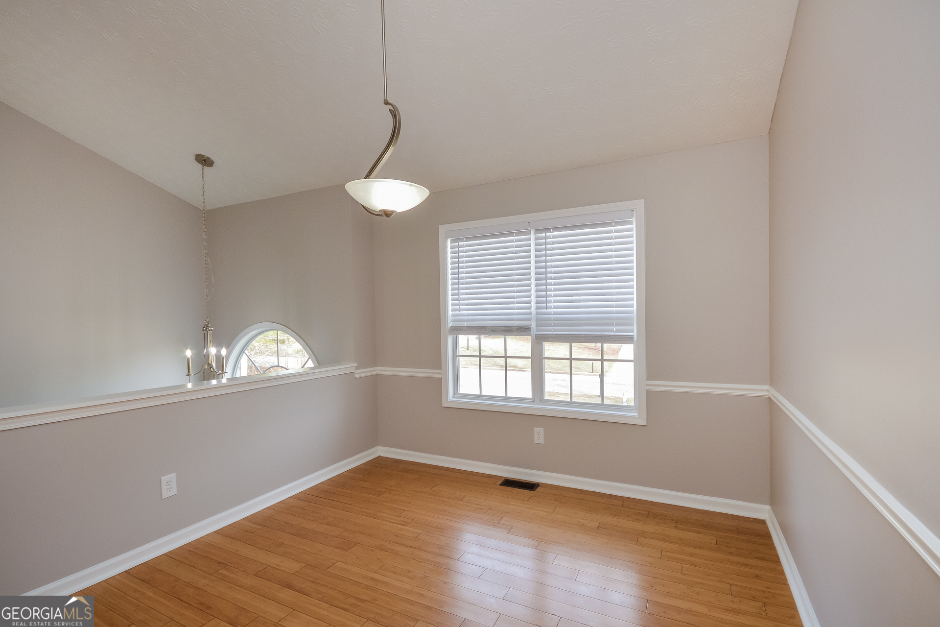 110 Tara Way Covington, GA 30016 - Photo 6 of 17 a view of an empty room with window and wooden floor