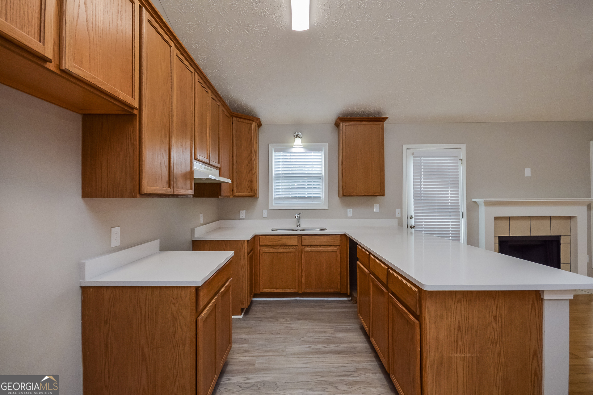 110 Tara Way Covington, GA 30016 - Photo 7 of 17 a kitchen with stainless steel appliances a sink stove and cabinets