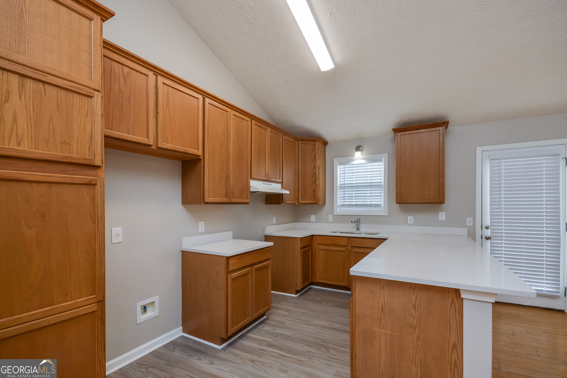 110 Tara Way Covington, GA 30016 - Photo 8 of 17 a kitchen with stainless steel appliances granite countertop a sink a stove and a refrigerator