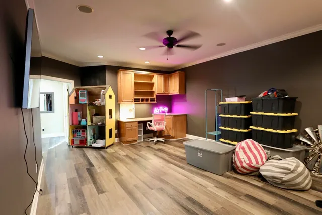 a living room with furniture gym equipment and a chandelier