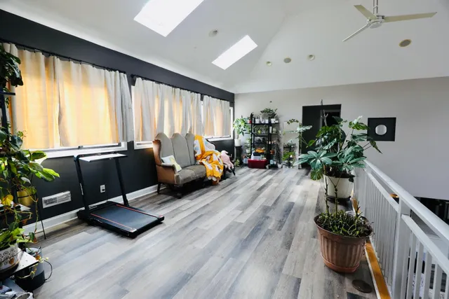 a living room with furniture window and wooden floor
