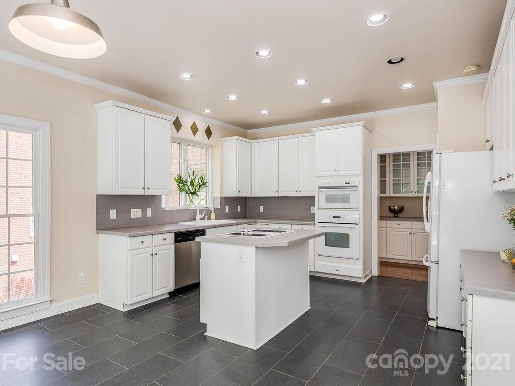 5530 Piper Glen Drive Charlotte, NC 28277 - Photo 11 of 35 a kitchen with kitchen island a sink stainless steel appliances and cabinets