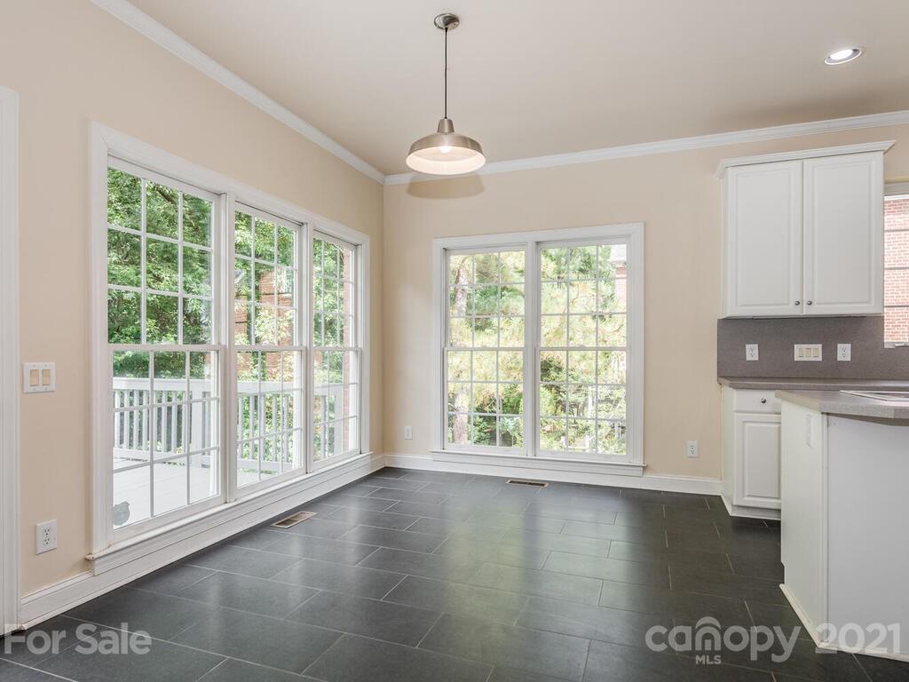 5530 Piper Glen Drive Charlotte, NC 28277 - Photo 12 of 35 a view of an empty room with wooden floor and a window