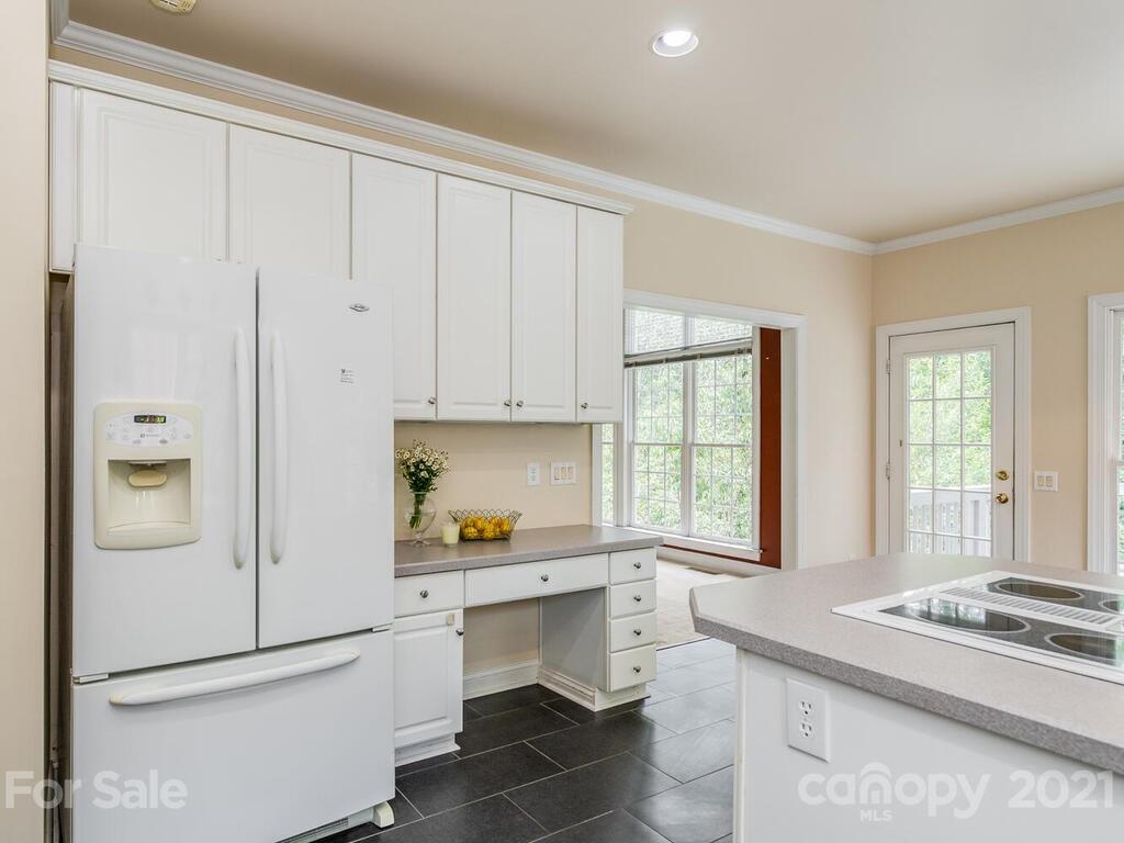 5530 Piper Glen Drive Charlotte, NC 28277 - Photo 14 of 35 a kitchen with a refrigerator and white cabinets