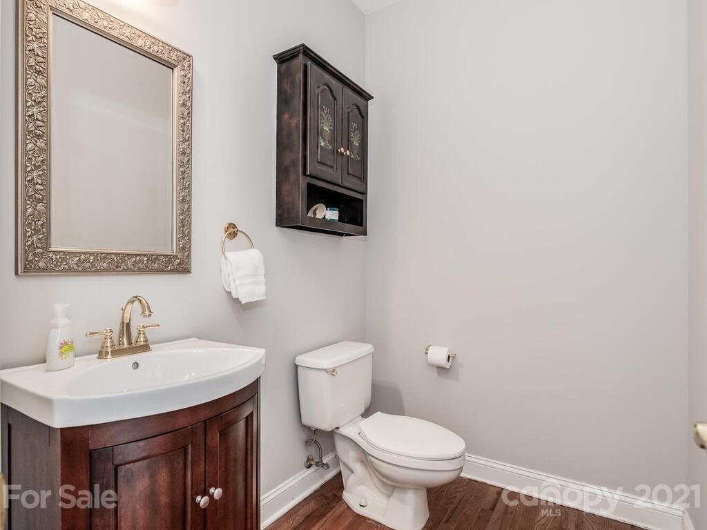 5530 Piper Glen Drive Charlotte, NC 28277 - Photo 18 of 35 a bathroom with a toilet a sink and mirror