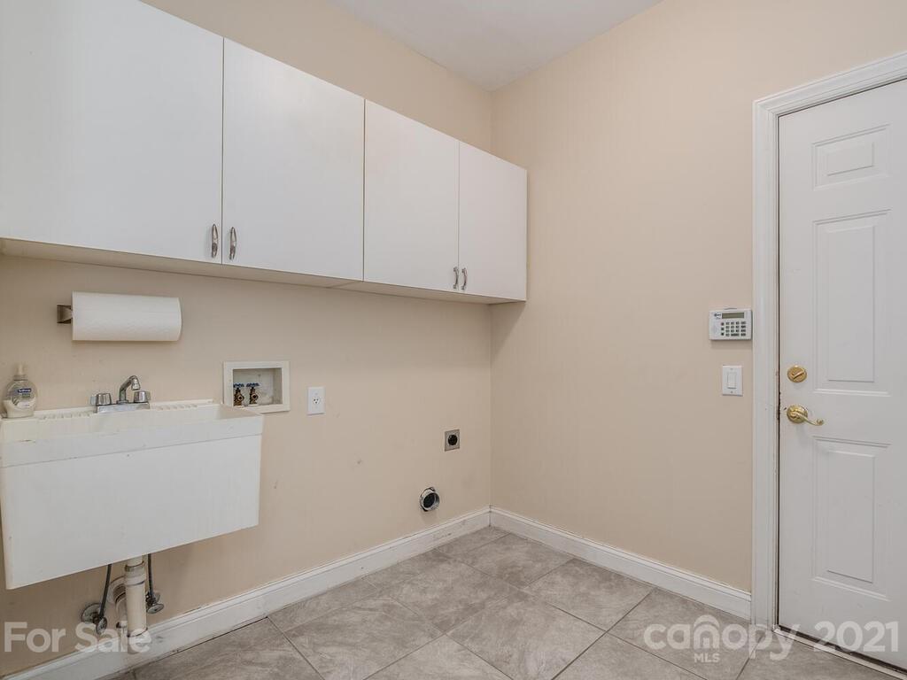 5530 Piper Glen Drive Charlotte, NC 28277 - Photo 19 of 35 a room with a white cabinets and washer