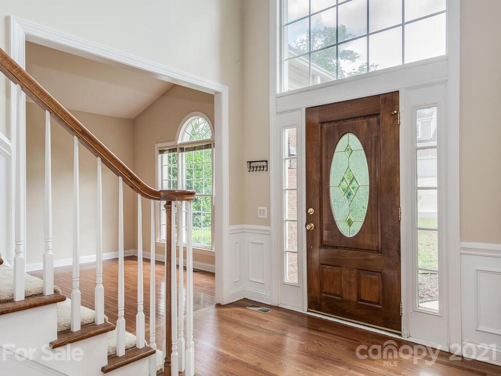 5530 Piper Glen Drive Charlotte, NC 28277 - Photo 3 of 35 a view of a hallway with wooden floor and a window