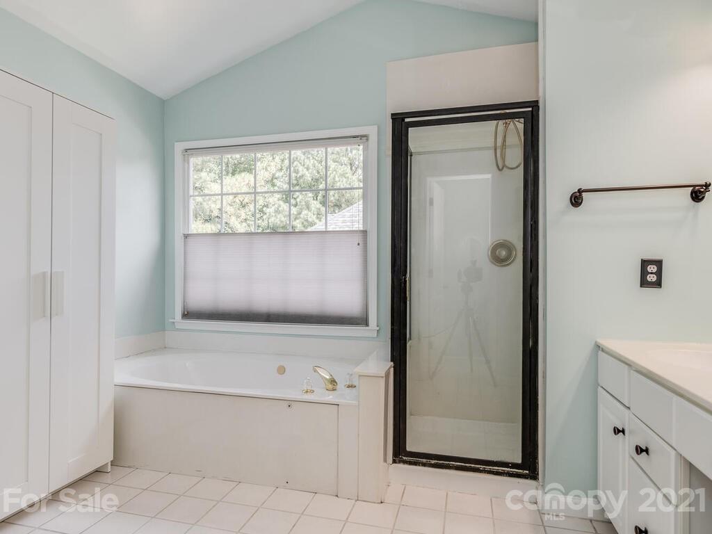 5530 Piper Glen Drive Charlotte, NC 28277 - Photo 22 of 35 a bathroom with a bathtub and a shower