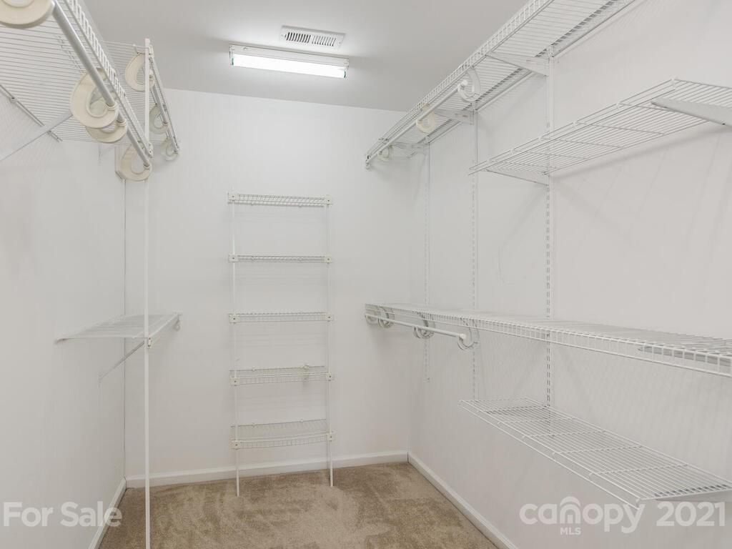 5530 Piper Glen Drive Charlotte, NC 28277 - Photo 23 of 35 a view of walk in closet with empty racks
