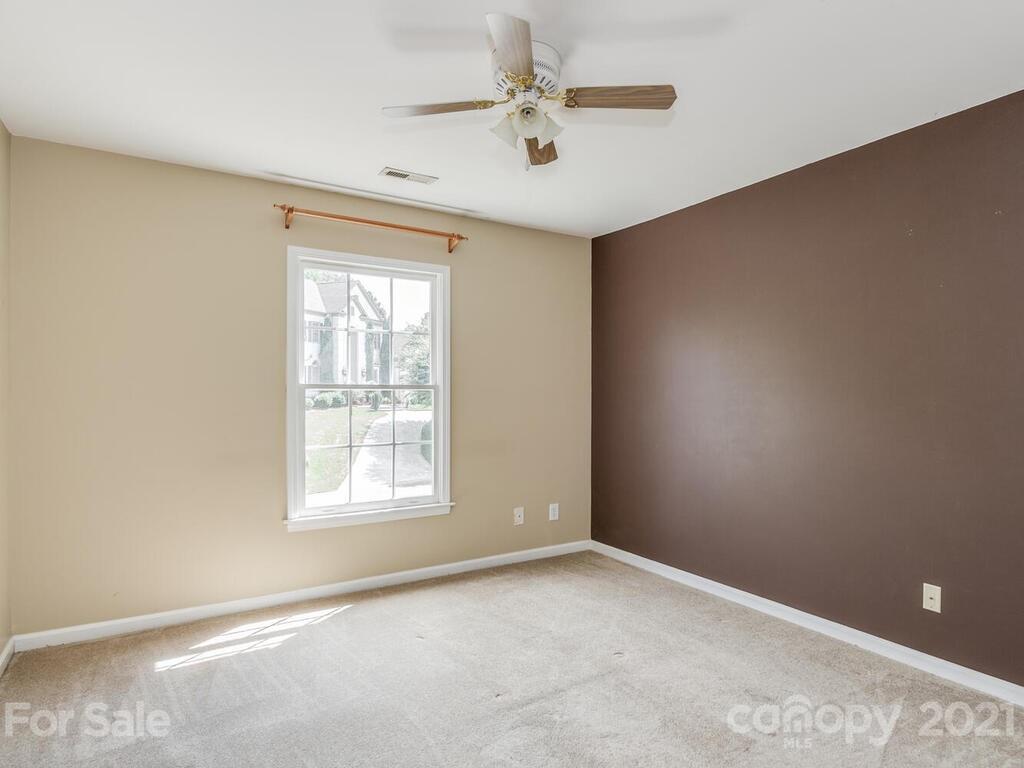 5530 Piper Glen Drive Charlotte, NC 28277 - Photo 24 of 35 an empty room with windows and fan