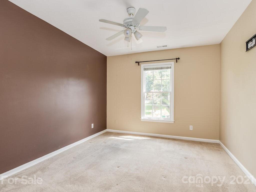5530 Piper Glen Drive Charlotte, NC 28277 - Photo 25 of 35 an empty room with windows and fan