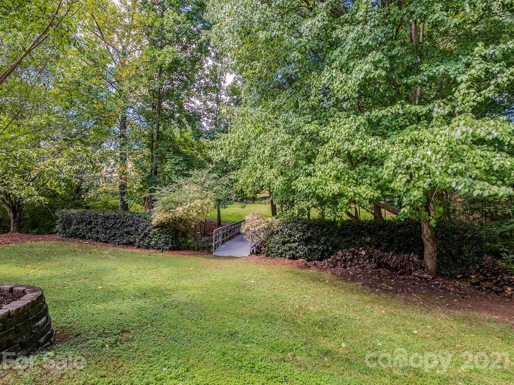 5530 Piper Glen Drive Charlotte, NC 28277 - Photo 33 of 35 a view of a backyard with plants and large trees