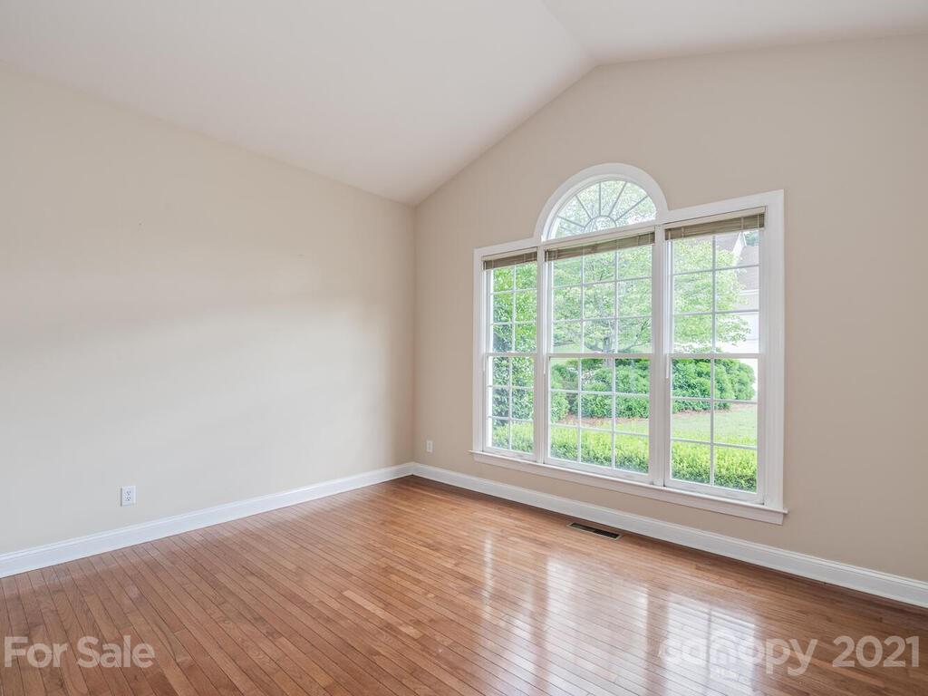 5530 Piper Glen Drive Charlotte, NC 28277 - Photo 5 of 35 a view of an empty room with wooden floor and a window